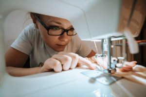 Woman sewing face mask for corona covid pandemic with sewing machine, Woman sewing face mask for corona covid pandemic with sewing machine,